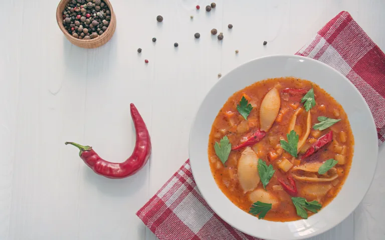 A hearty soup featuring pasta, herbs and vibrant peppers, perfect for a flavorful and healthy meal.