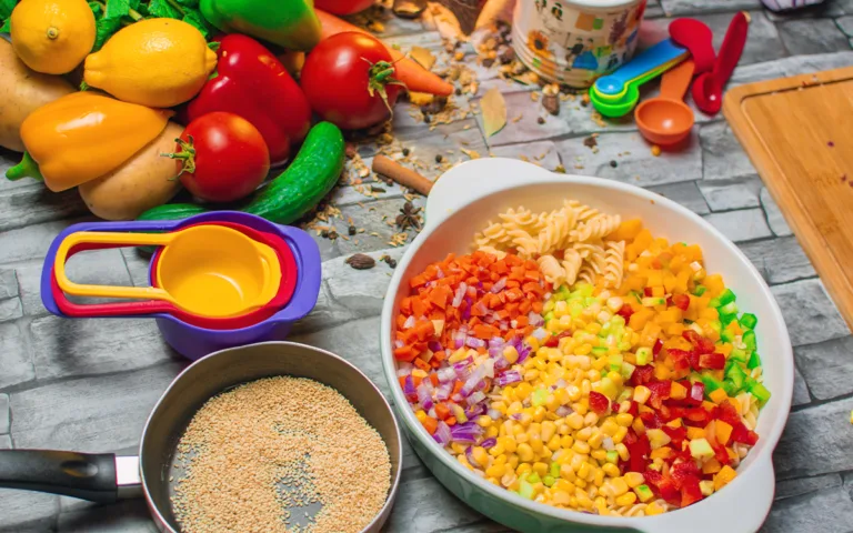 A bowl filled with colorful pasta, fresh vegetables, and spices, emphasizing the importance of a nutrient-rich diet.