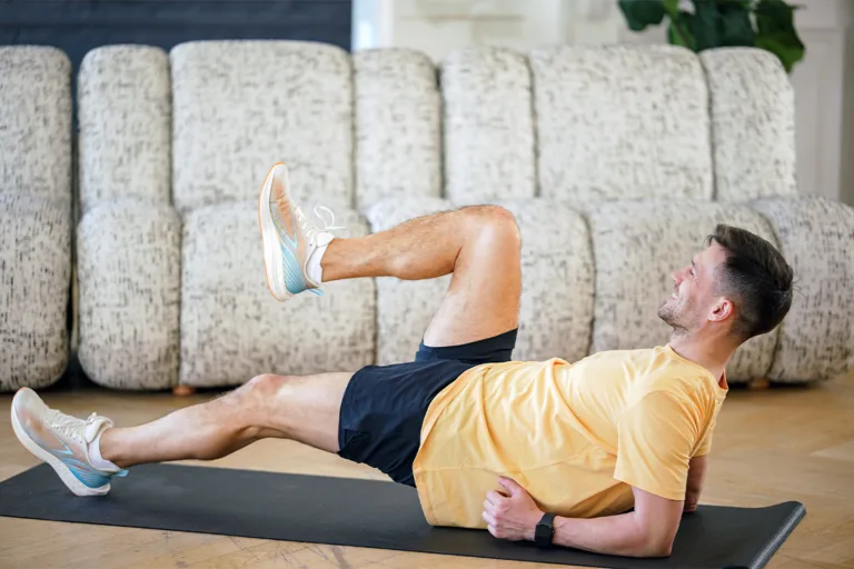 A man performs leg exercises on a mat, emphasizing the importance of not skipping leg day in fitness routines.