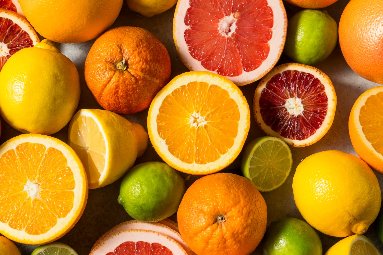 Fresh oranges, grapefruit, lemons, and limes rich in vitamin C, supporting immunity, skin health, and antioxidant balance for women over 50.
