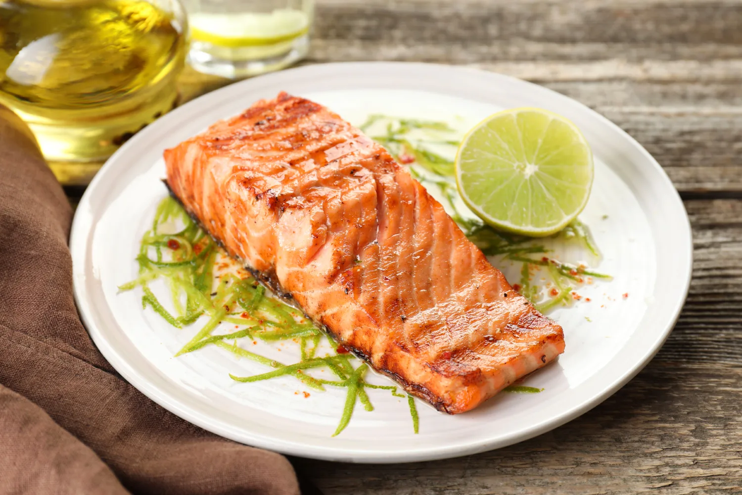 Grilled salmon with lime, a natural source of vitamin D and omega-3s, supporting bone health, heart wellness, and aging women’s nutrition.