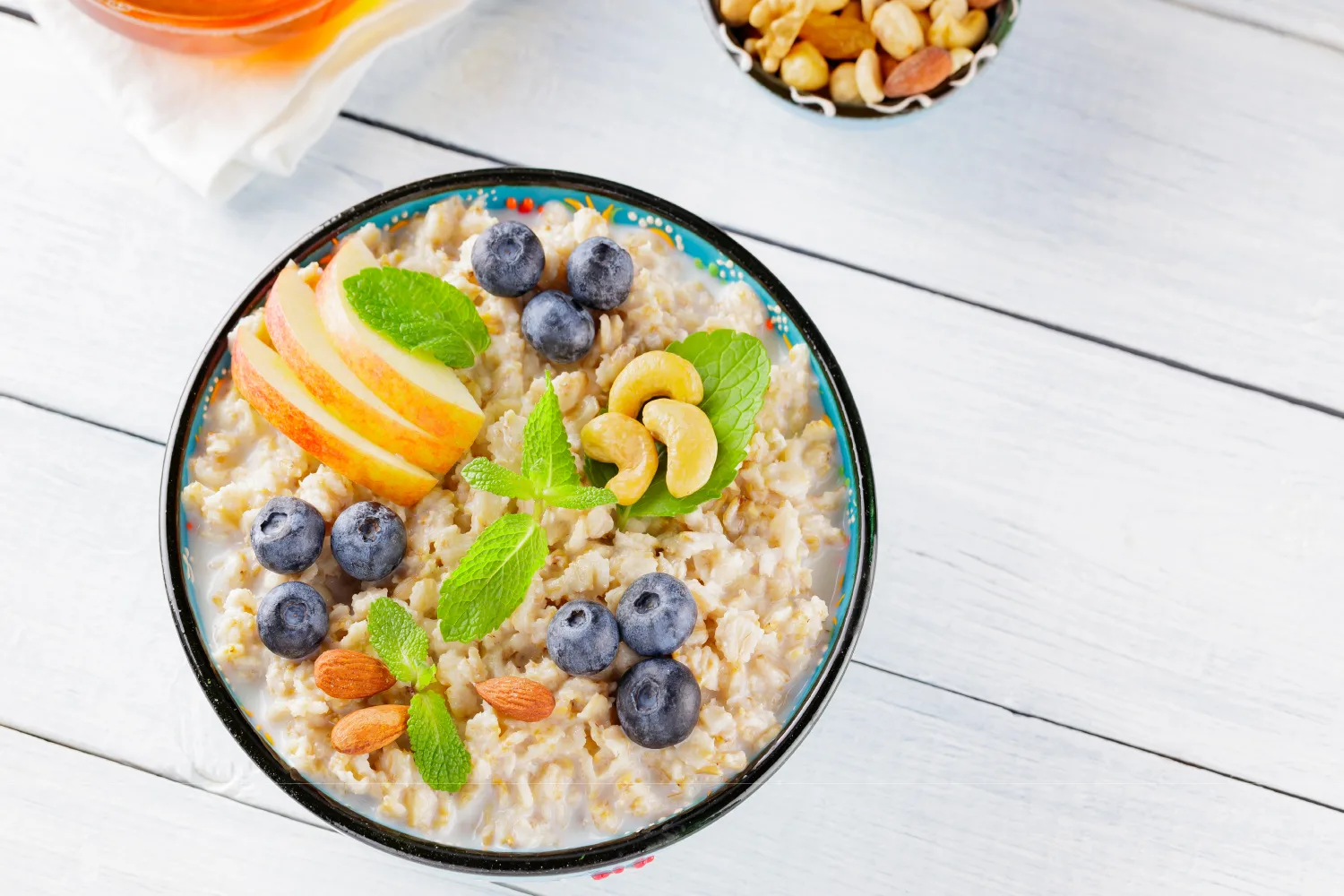 Heart healthy oatmeal topped with fruits and nuts to support cholesterol balance and cardiovascular wellness