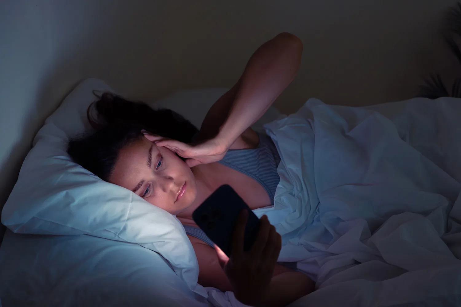 Late-night screen use affecting sleep quality and mood, highlighting the importance of healthy habits in February wellness planning