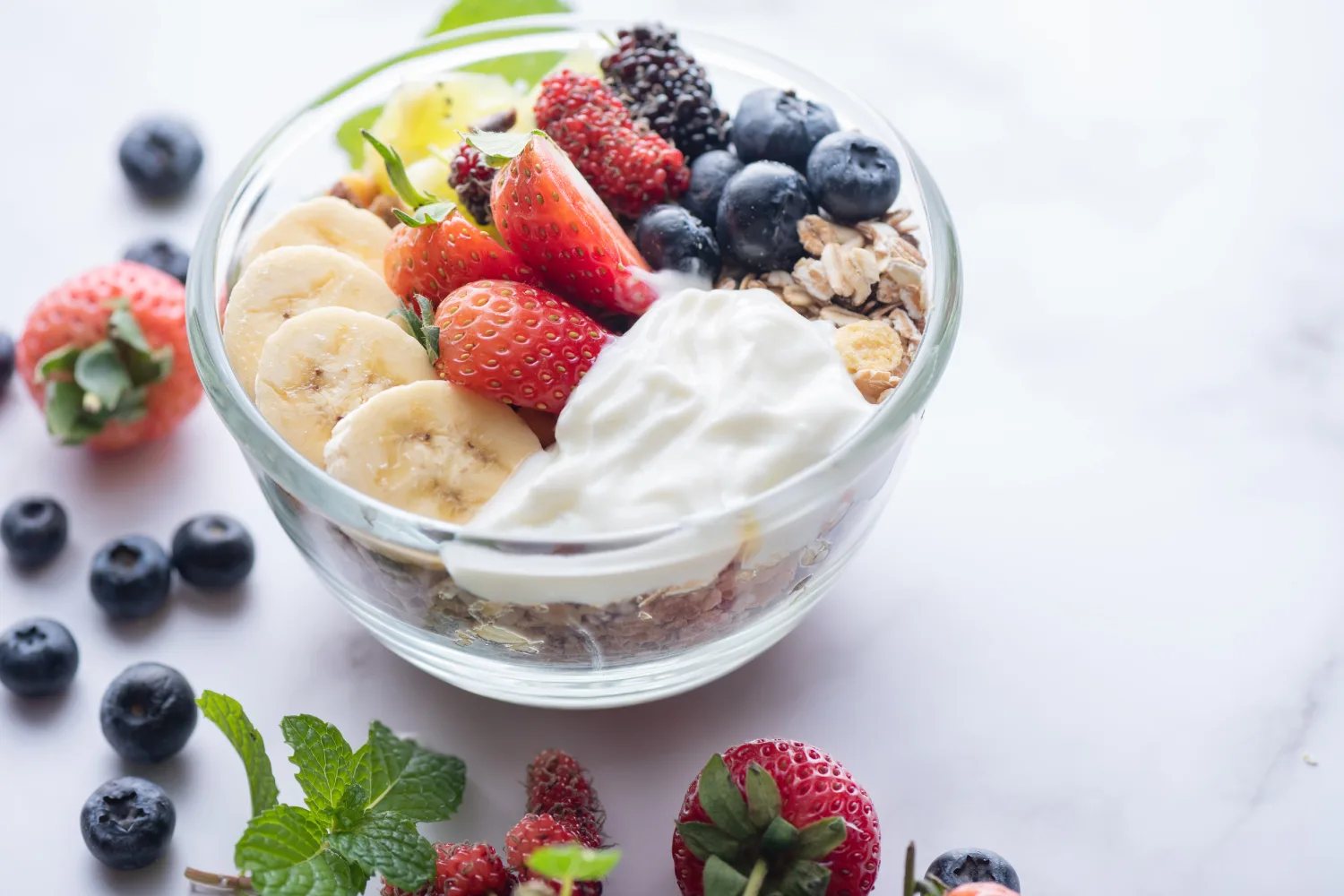 Yogurt bowl with fresh fruits, granola, and berries, highlighting a balanced menopause-friendly recipe that supports mood, digestion, and sustained energy.