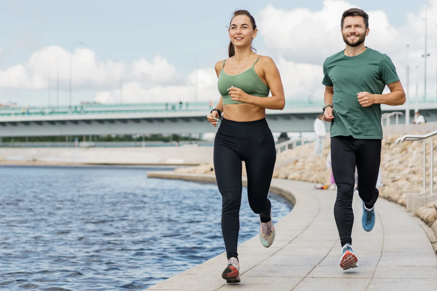 Two people jogging outdoors representing healthy lifestyle habits that support balanced energy, appetite control, and reduced cravings