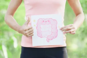 Person holding a gut health illustration with thumbs up to represent digestive wellness and simple ways to support gut health naturally
