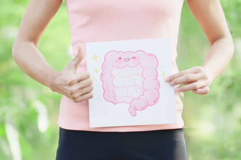 Person holding a gut health illustration with thumbs up to represent digestive wellness and simple ways to support gut health naturally