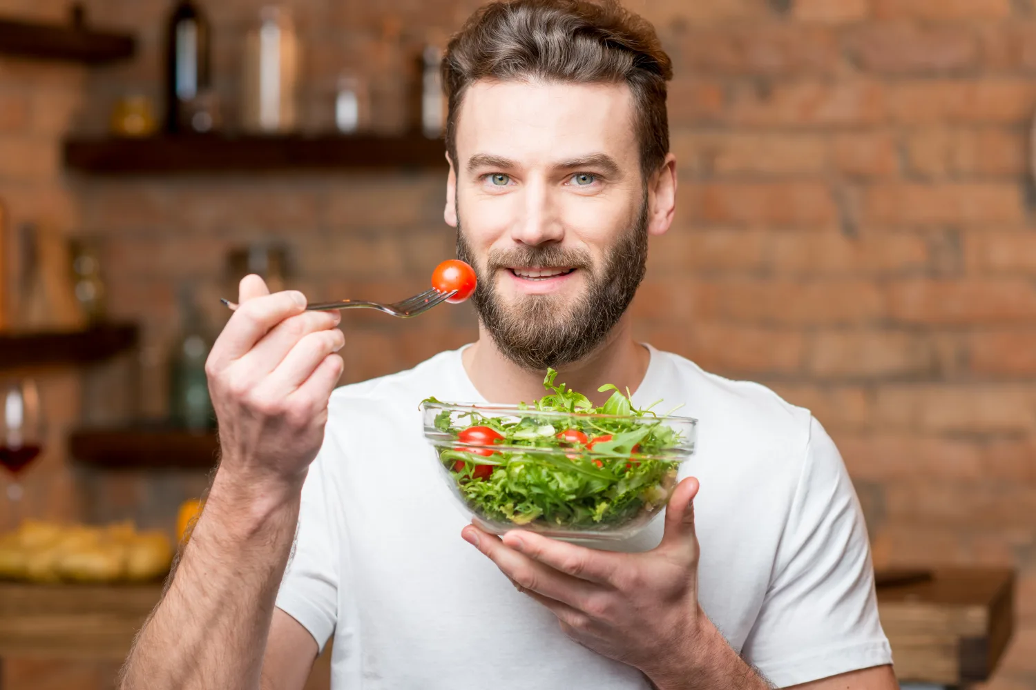 Man eating a fresh salad as part of a healthy diet to support digestion, gut balance, and natural digestive wellness