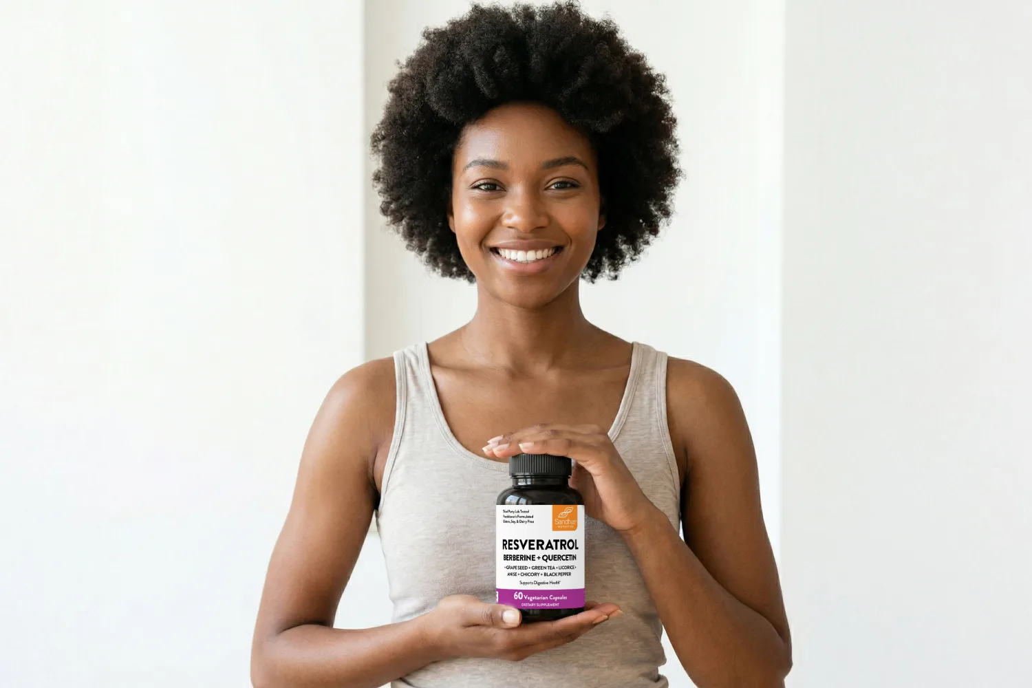 Woman holding a resveratrol supplement bottle to represent simple daily ways to support gut health and digestive balance