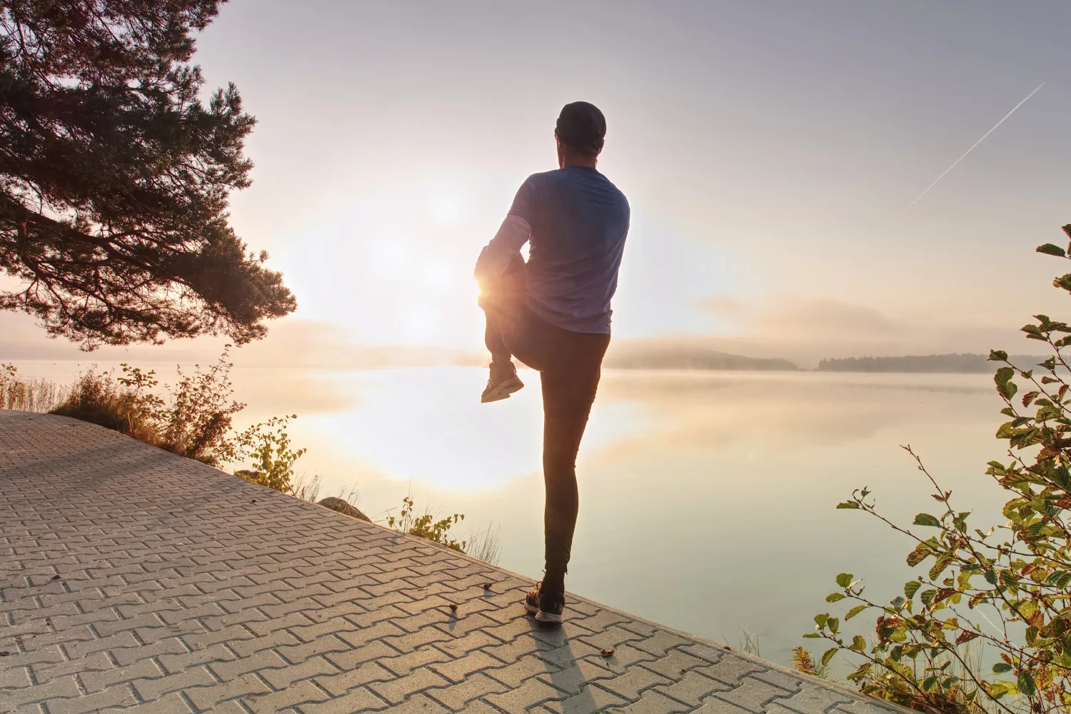 Person stretching outdoors during sunrise supporting physical activity and overall wellness during spring season