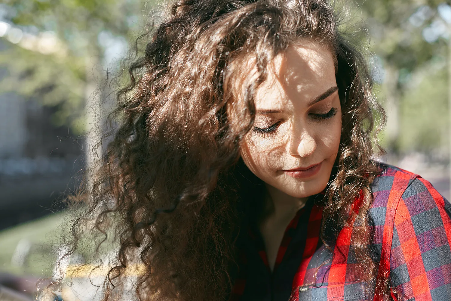 Close up of woman with thick curly hair showing healthy hair texture supported by essential nutrients like biotin, zinc, iron and vitamins