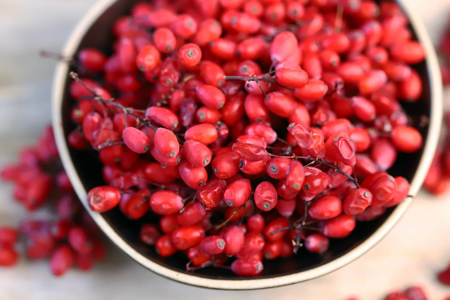 Berberine-rich red berries in a bowl, representing natural plant compounds and the role of timing berberine for better results