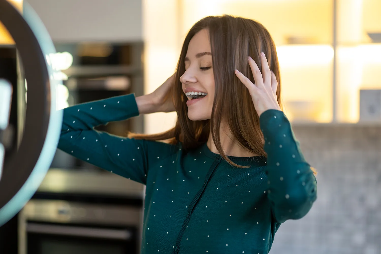 Young woman smiling and touching healthy shiny hair showing improved hair strength and growth support.