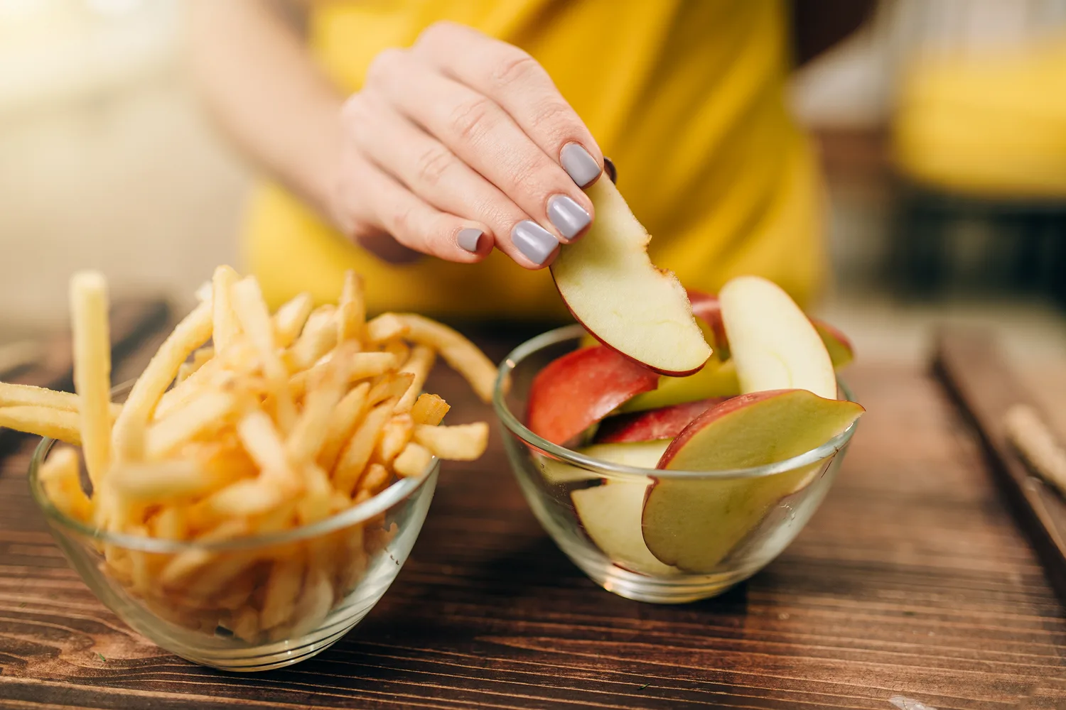 Choosing apple slices over fries to support balanced snacking habits and reduce unnecessary food cravings